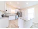 Modern kitchen with white cabinets, a tile backsplash, and stainless steel appliances at 2486 Ainsworth Ave, Deltona, FL 32738