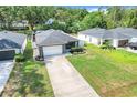 Stunning one-story home with well-kept lawn, driveway, and neighboring buildings at 25106 Quaker Ridge Ave, Sorrento, FL 32776