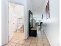 Hallway view showcasing tile flooring, seating area and half bathroom at 2662 Mayaguana St, Kissimmee, FL 34747