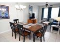 Dining room with seating for six, tile floor and overhead chandelier at 2785 Almaton Loop # 204, Kissimmee, FL 34747