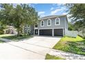 A spacious home featuring a three-car garage, ample driveway space, and attractive curb appeal with a well-kept lawn at 3063 Mandolin Dr, Kissimmee, FL 34744