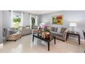 Comfortable living room with stylish furniture, decorative pillows, and natural light from arched windows at 3063 Mandolin Dr, Kissimmee, FL 34744