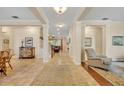 Inviting foyer with tile floors, decorative columns, and a view into the living spaces at 369 Torgiano Dr, Ocoee, FL 34761