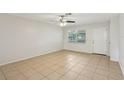 Bright, light-filled living room with neutral walls, tile flooring, and ceiling fan at 384 Zinnia Dr, Casselberry, FL 32707