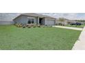 Well-kept home with green lawn, and a two-car garage at 392 Citrine Loop, Kissimmee, FL 34758