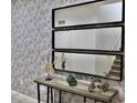 Inviting tiled entryway enhanced by decorative mirrors and a stylish console table with accent pieces at 5273 Oakbourne Ave, Davenport, FL 33837