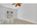 Bright living room with tile flooring and glass doors that lead to the backyard, flooding the space with natural light at 5505 W Magnolia Ave, Port Orange, FL 32127