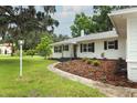 Landscaped front yard leads to this recently renovated home with fresh paint and new walkway at 656 Lake Charm Dr, Oviedo, FL 32765