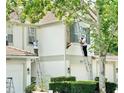 A view of the exterior facade of the home, showing landscapers on ladders doing exterior work at 7054 Cadiz Blvd, Orlando, FL 32819