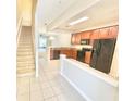 Eat-in kitchen featuring wooden cabinetry, granite counters, and black appliances at 7054 Cadiz Blvd, Orlando, FL 32819