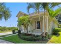 Side exterior with lush landscaping featuring palm trees, offering a glimpse of its charming architectural details at 7201 Halton Ct, Windermere, FL 34786