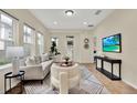 Bright living room features modern decor and furniture with a large window offering ample natural light at 8245 Laureate Blvd, Orlando, FL 32827