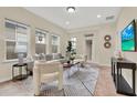 Comfortable living room with modern geometric rug, plush seating, and contemporary decor at 8245 Laureate Blvd, Orlando, FL 32827