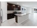 Modern kitchen with stainless steel appliances, granite countertops, and a center island at 856 Teton St, Haines City, FL 33844