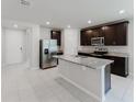 Contemporary kitchen featuring granite countertops, stainless steel appliances, and island at 856 Teton St, Haines City, FL 33844