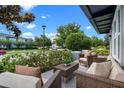 Relaxing outdoor seating area on the front porch, perfect for enjoying the neighborhood views and fresh air at 8692 Tavistock Lakes Blvd, Orlando, FL 32827
