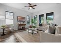 Inviting living room featuring stylish floors, abundant natural light, comfortable seating, and a cozy rug at 8692 Tavistock Lakes Blvd, Orlando, FL 32827