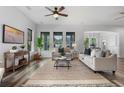 Spacious living room with a large rug, comfortable seating, and lots of natural light at 8692 Tavistock Lakes Blvd, Orlando, FL 32827