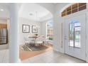 Bright dining room with modern chandelier, white dining set, and lots of natural light at 9330 Shadow Pinar Ct, Orlando, FL 32825