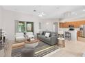 Open concept living room featuring a modern fireplace, couch, and lots of seating at 9330 Shadow Pinar Ct, Orlando, FL 32825