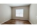 Cozy room featuring hardwood floors, neutral paint, and a window for natural light at 9917 Summerlake Groves St, Winter Garden, FL 34787