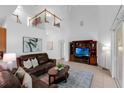 Bright living room featuring a vaulted ceiling, tile floors and a second story balcony at 10125 Sandy Marsh Ln, Orlando, FL 32832