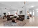 Spacious living room with tile floors, vaulted ceiling, and a stylish, neutral color scheme at 10125 Sandy Marsh Ln, Orlando, FL 32832