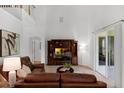 Bright living room boasts soaring ceilings, neutral colors, and tile floors, creating a spacious atmosphere at 10125 Sandy Marsh Ln, Orlando, FL 32832