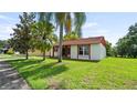 A charming single-story home with a well-maintained lawn and mature trees providing shade and curb appeal at 10169 Matchlock Dr, Orlando, FL 32821