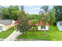Beautiful single-story home with lush lawn, mature landscaping, and a red tile roof enhancing its curb appeal at 10169 Matchlock Dr, Orlando, FL 32821