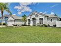 Lovely home with well-kept lawn, complemented by beautiful trees and inviting architecture at 1034 Alvina Ln, Oviedo, FL 32765
