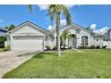 Well-maintained single-Gathering home features a manicured lawn and inviting curb appeal at 1034 Alvina Ln, Oviedo, FL 32765