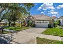 Charming single-story home with tile roof, lush landscaping, and a two-car garage at 1855 Vista Royale Blvd, Orlando, FL 32835