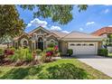 Charming single-story home with tile roof, lush landscaping, and a two-car garage at 1855 Vista Royale Blvd, Orlando, FL 32835