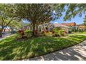 Well-manicured lawn and landscaping complement this charming single-story home with tile roof at 1855 Vista Royale Blvd, Orlando, FL 32835