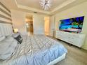 Comfortable main bedroom with a large dresser and an en-suite bathroom at 2034 Fleming Mist Pl, Kissimmee, FL 34747
