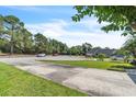 A quiet street view showcases a well-manicured lawn and a charming single-story home in a peaceful neighborhood at 227 Morning Glory Dr, Lake Mary, FL 32746