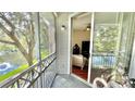 Screened balcony with sliding glass doors offering a view of the lake and access to the living area at 2314 Mid Town Ter # 1126, Orlando, FL 32839