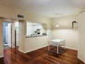 Bright living area showcases kitchen access, wood floors, and neutral colors at 2314 Mid Town Ter # 1126, Orlando, FL 32839