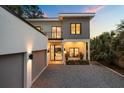 Contemporary home showcasing a gray and white exterior, a balcony, and a two-car garage at 2412 Chantilly Ave, Winter Park, FL 32789