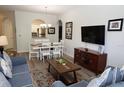 Comfortable living room with an open view to the dining area and kitchen for easy entertaining at 2778 Almaton Loop # 302, Kissimmee, FL 34747