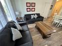 Comfortable living room with wood floors, gray couches, stylish decorations, and an open layout, perfect for relaxing and entertaining at 2778 Almaton Loop # 302, Kissimmee, FL 34747