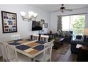 Cozy living room featuring a dining table, comfortable sofa, TV, and a balcony with natural light at 2778 Almaton Loop # 302, Kissimmee, FL 34747