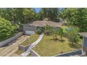 Charming home with a well-manicured lawn, gray brick, and inviting walkway at 300 Hickory Ct, Apopka, FL 32712