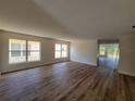 Spacious living room showcasing new flooring, large windows, and plenty of natural light at 3156 Natoma Way, Orlando, FL 32825
