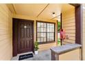 Inviting condo entrance with a welcome mat and well-lit porch at 325 Forestway Cir # 104, Altamonte Springs, FL 32701