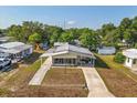 Overhead view of a cozy home with a long driveway and mature landscaping at 38 Da Rosa Ave, Debary, FL 32713