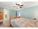 Spacious bedroom showcasing ceiling fan and view into adjacent bathroom at 38 Da Rosa Ave, Debary, FL 32713