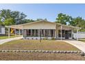 Inviting single-story home showcasing a well-maintained lawn and long carport at 38 Da Rosa Ave, Debary, FL 32713