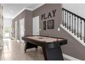 Hallway with an air hockey table, stairway, and playful decor for entertainment at 4375 Scene Ln, Kissimmee, FL 34746